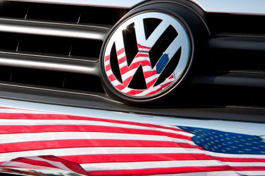 epa04942152 (FILE) A file photo dated 13 May 2009 of a US flag being reflected in the logo and front of a Volkswagen car in Chattanooga, Tennessee, USA. Volkswagen's shares plunged on 21 September 2015 after US environmental protection authorities threatened to impose fines of up to 18 billion dollars on the carmaker, following its admission of systematically cheating US air pollution tests. EPA/FRISO GENTSCH